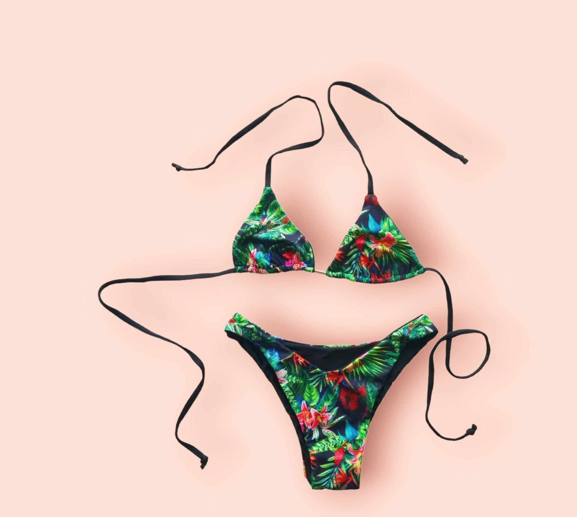 a bikini top with a tropical print on it