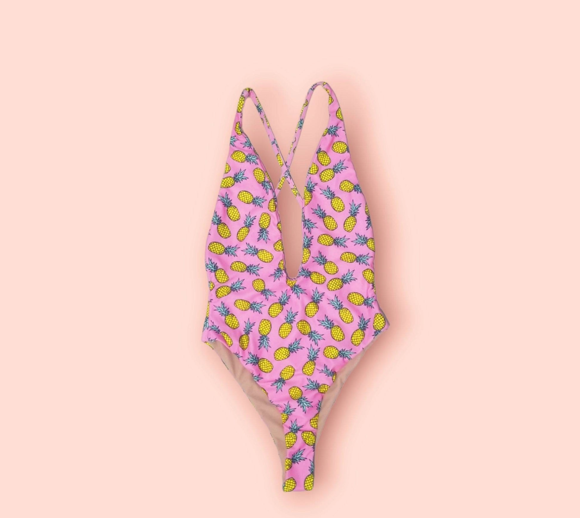 a pink and yellow bikini with pineapples on it