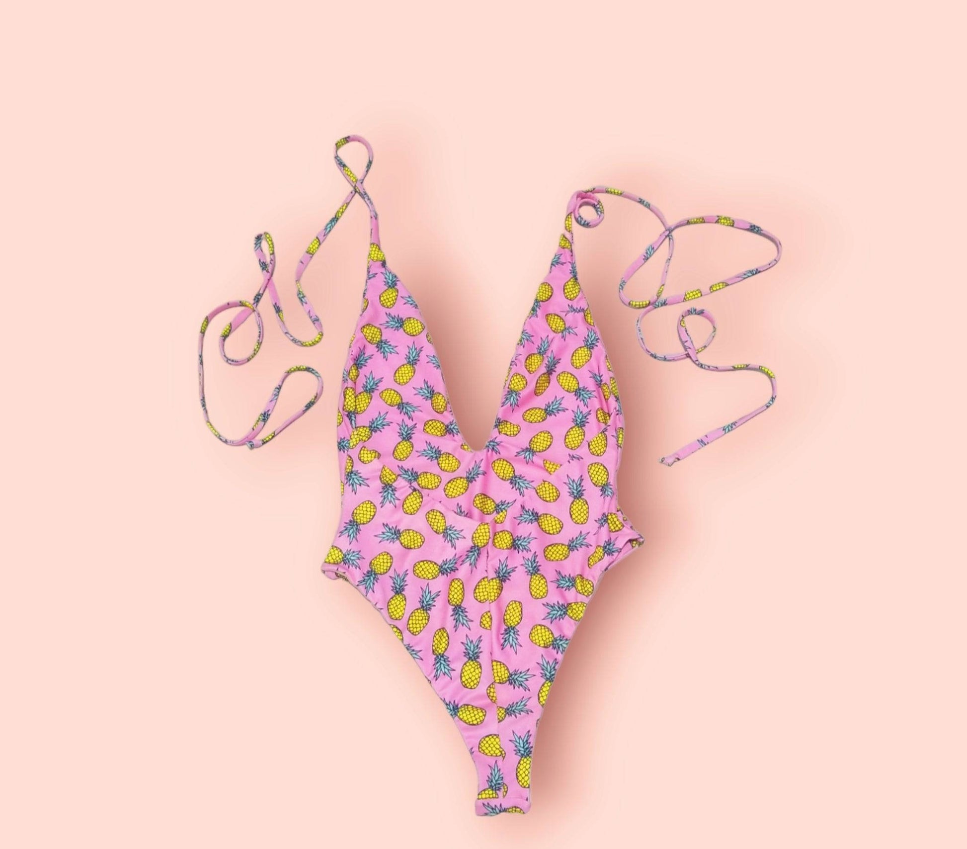 a pink bikini top with pineapples on it