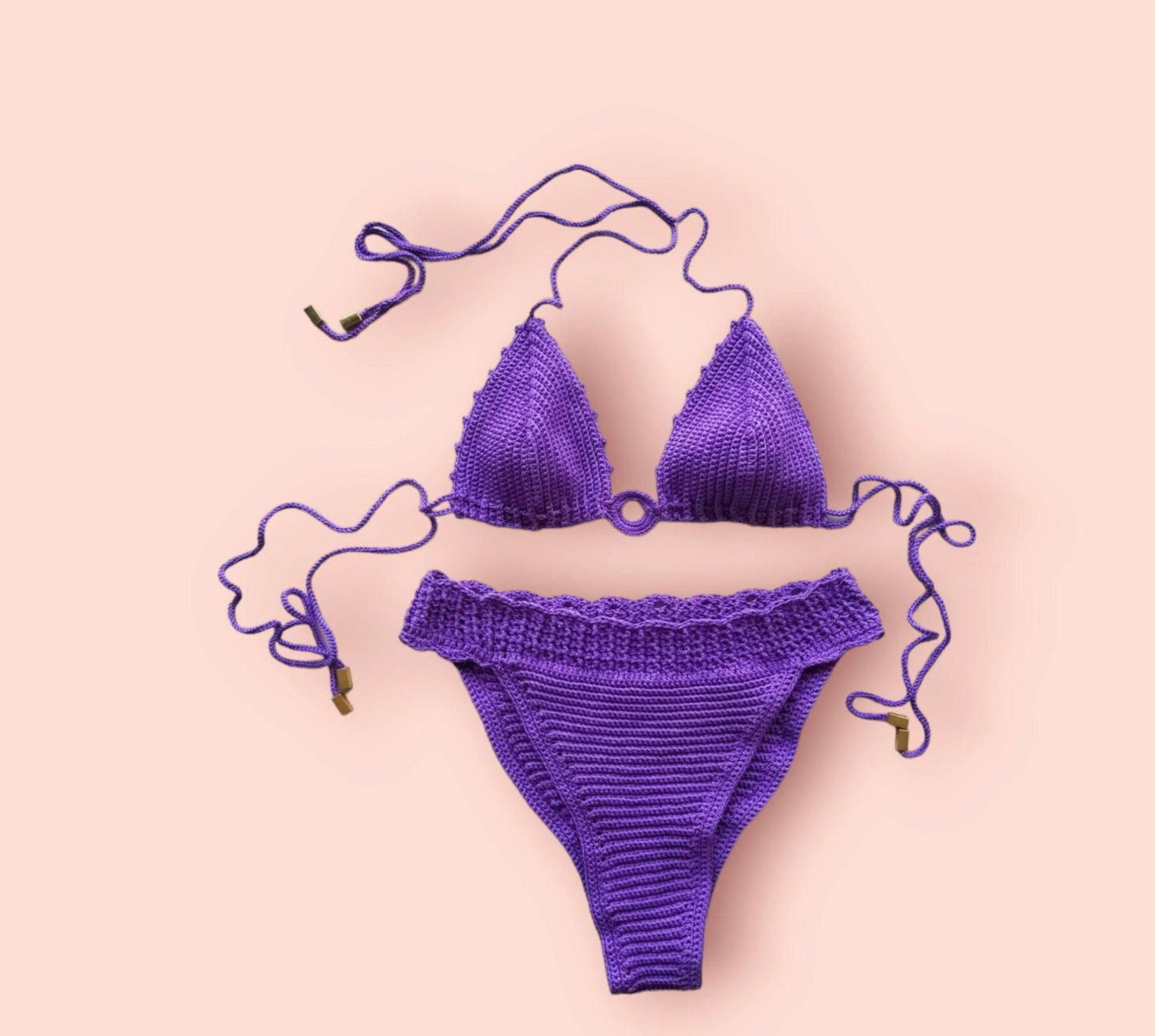 a purple bikini with a crochet tie attached to it