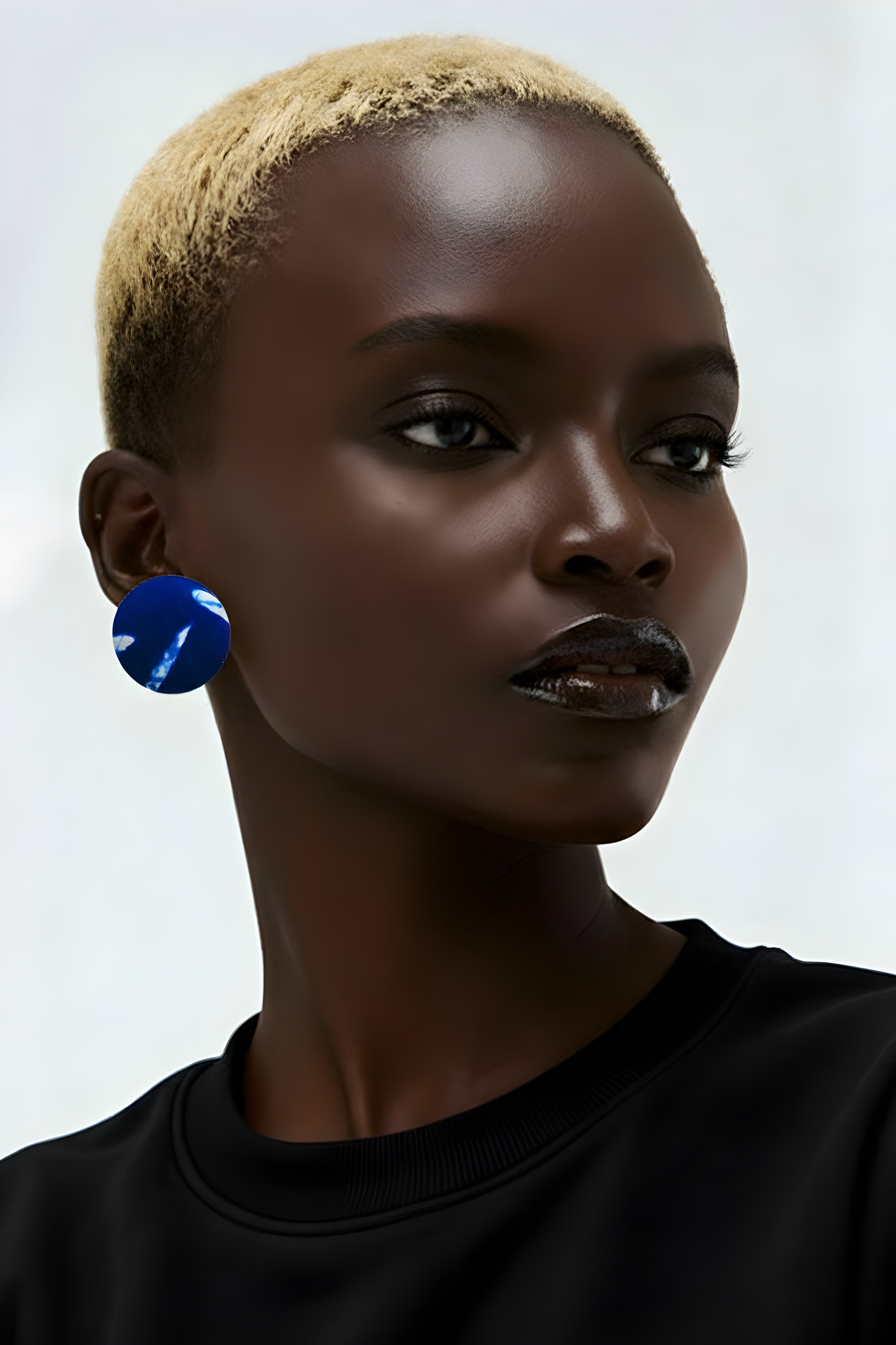 Scope and Flow Amina button studs wrapped in a deep royal blue and white patterned African textile.