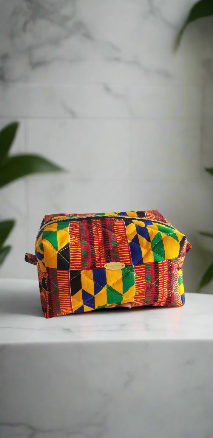 Close-up detail of the red and white geometric tribal pattern on the Scope and Flow makeup bag.