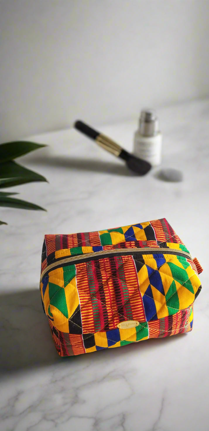 Side perspective of the handmade red tribal makeup bag styled with luxury bathroom fixtures.