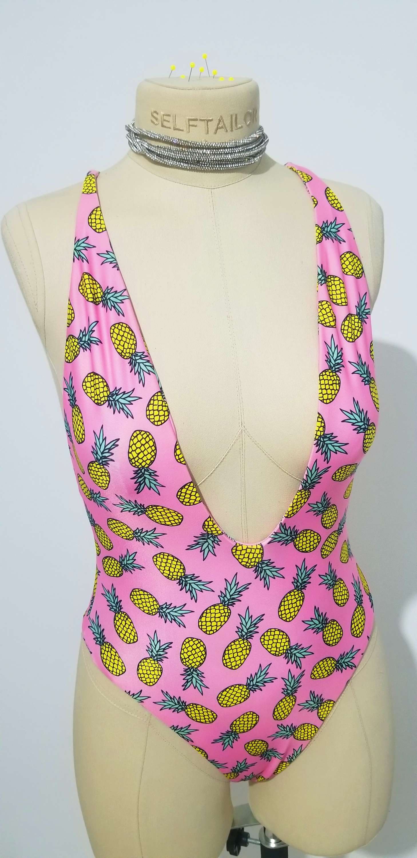 Rear view of the Helix bodysuit featuring the sleek, fixed cross-strap back design.