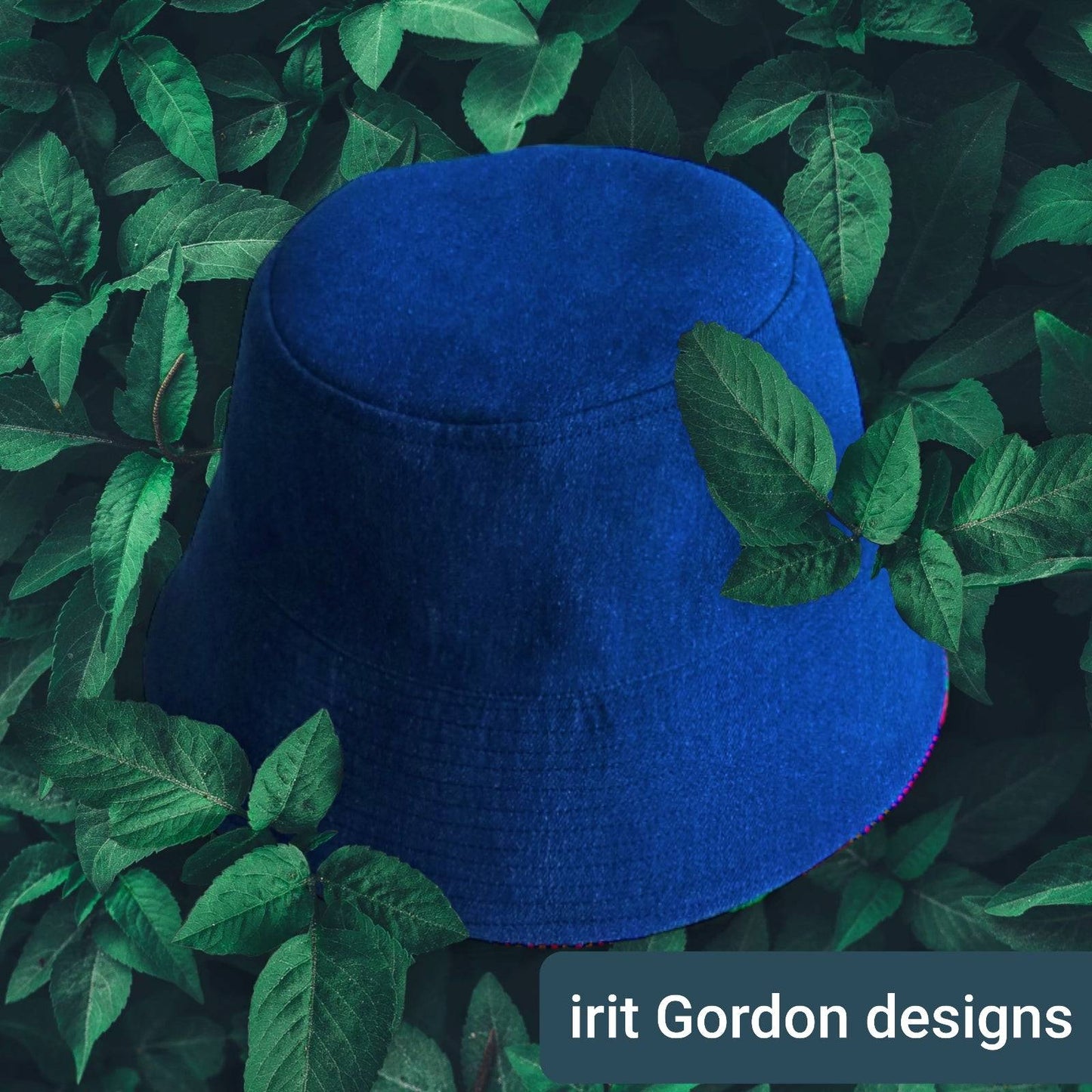 Side profile of the indigo and white artisan bucket hat on a luxury marble surface.