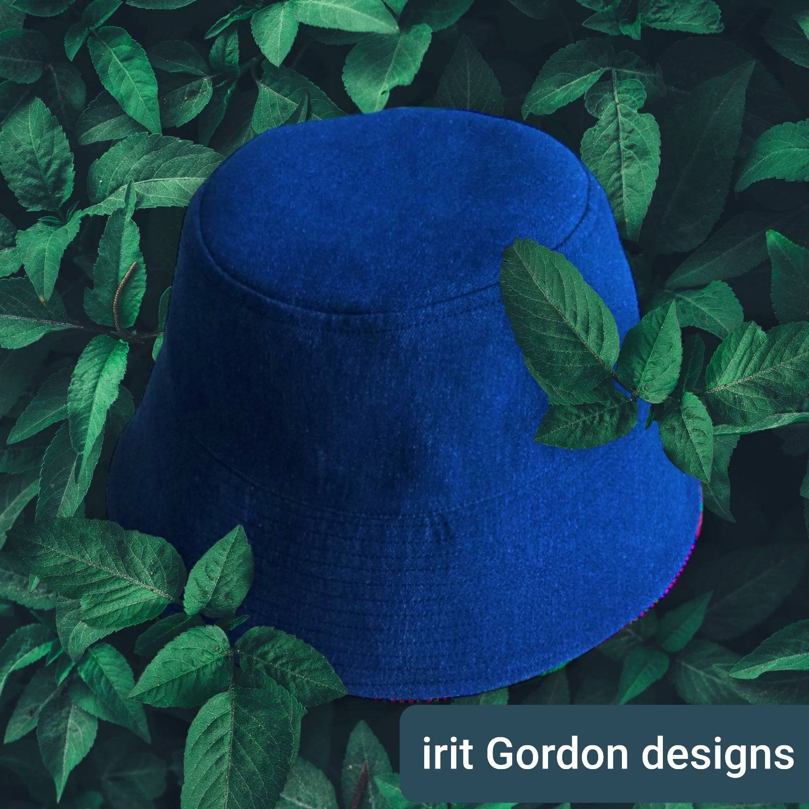 Side profile of the indigo and white artisan bucket hat on a luxury marble surface.