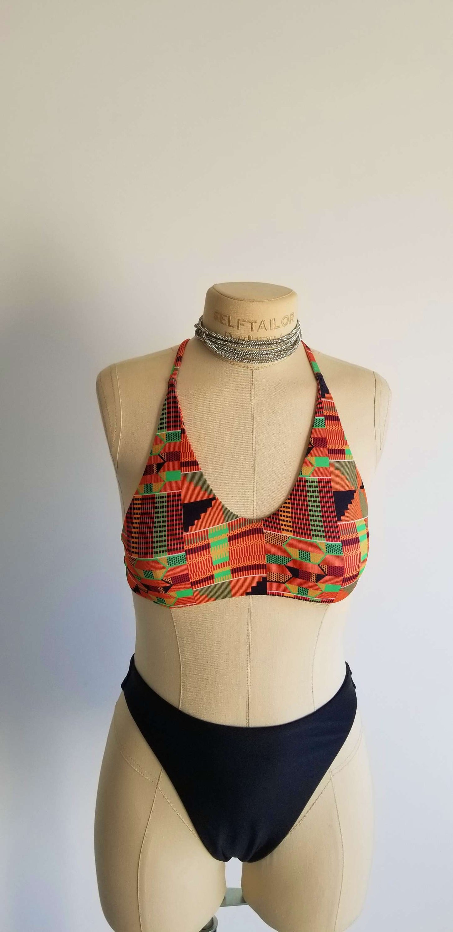 Close-up of the vibrant African print pattern and premium stitching on the handcrafted Heritage Infinity top.