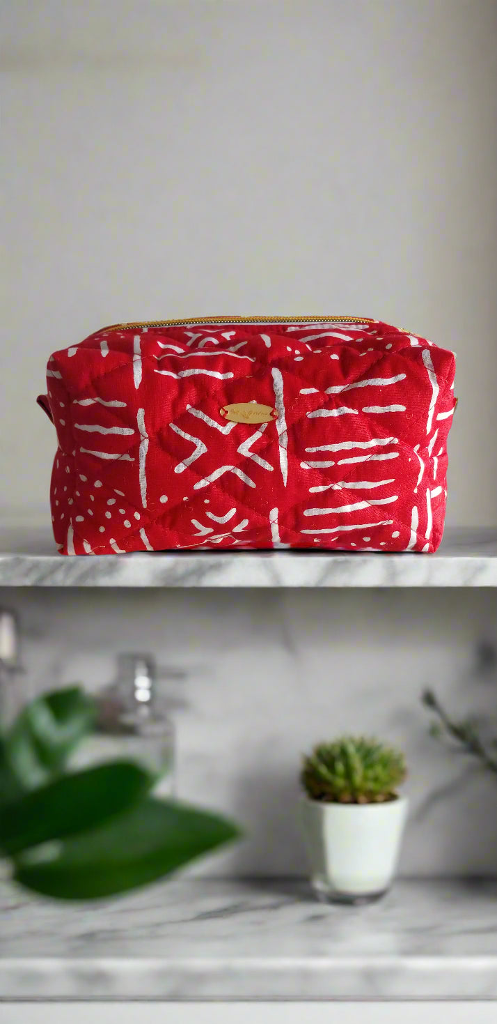 Close-up detail of the crimson and white geometric tribal pattern on the Scope and Flow Ruby makeup bag.
