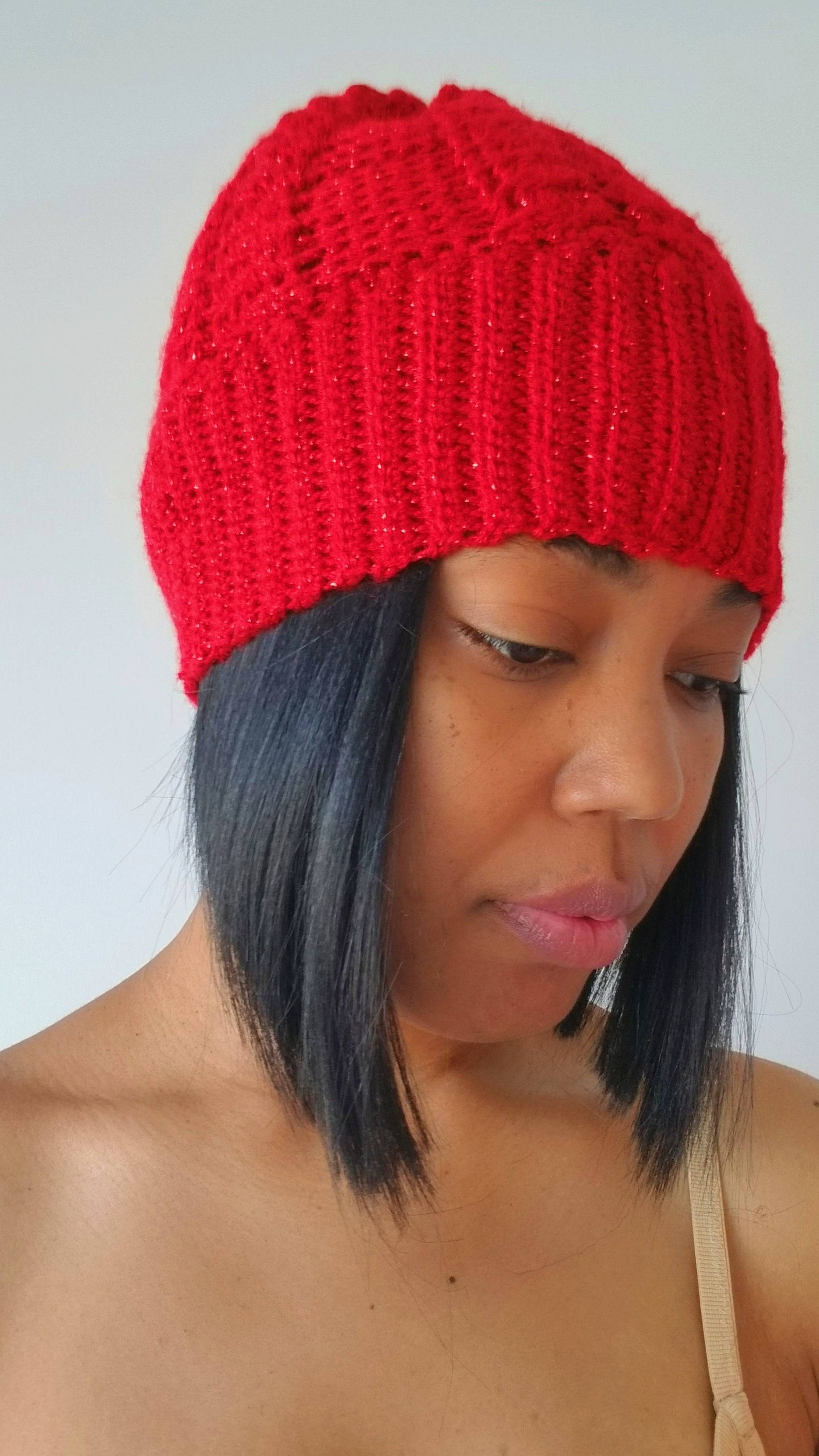 a woman wearing a red knitted hat