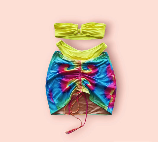 A tie-dye swimsuit fabric skirt with an adjustable side tie by Scope and Flow.