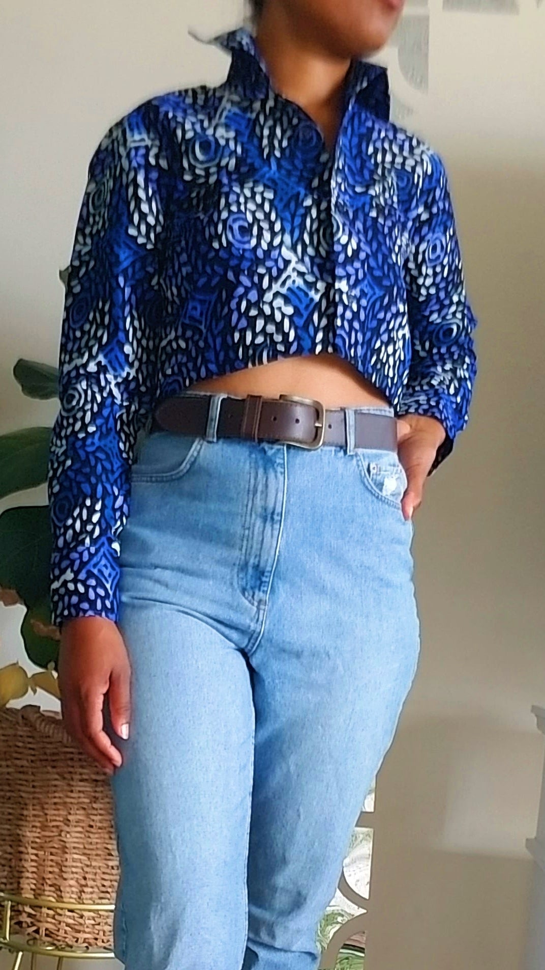 Detailed view of the Zola Cropped Button-Down in a deep blue and gold geometric African print fabric.