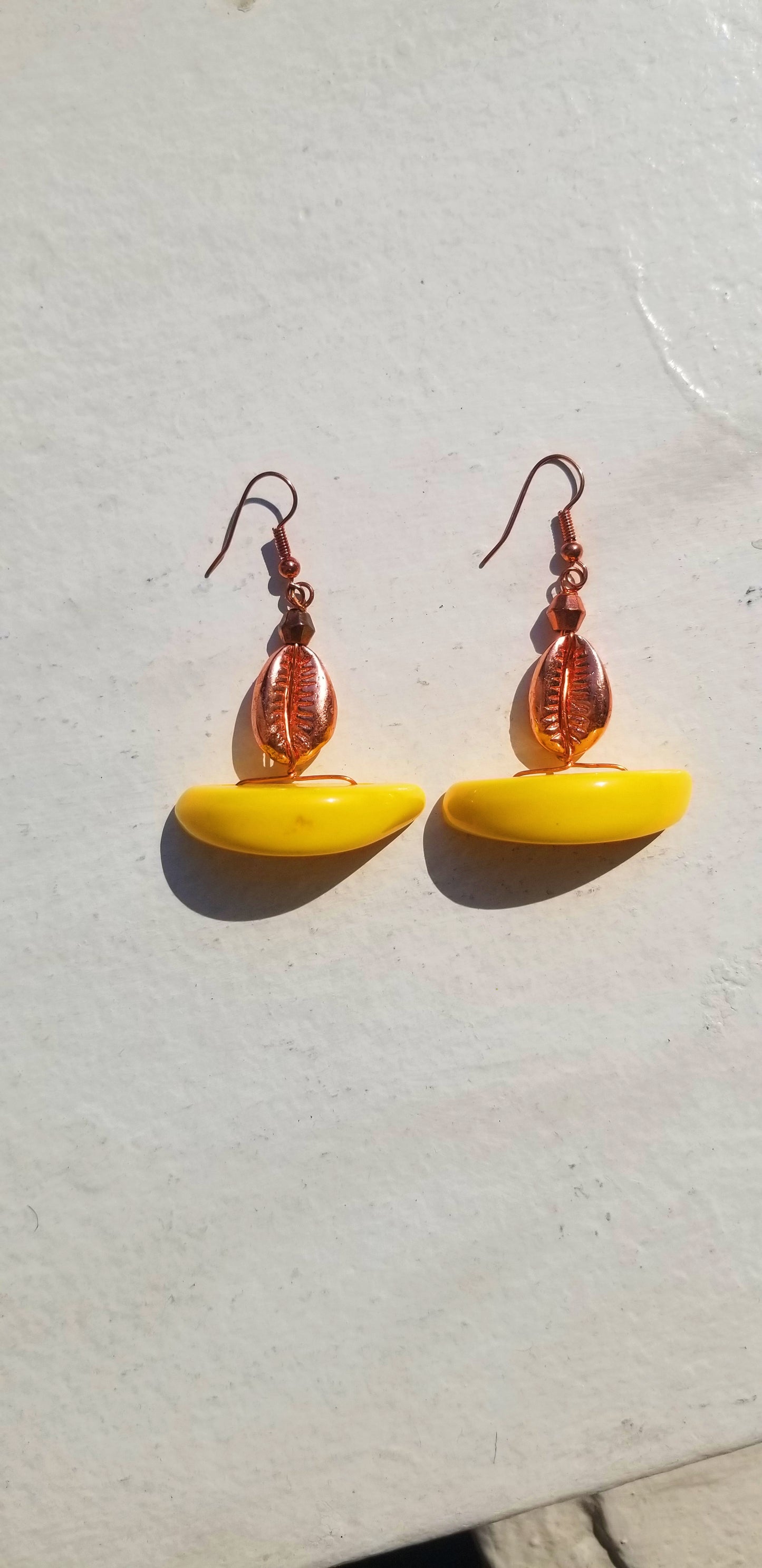 Bright canary yellow resin half-moon earrings for a bold, sunny luxury look.