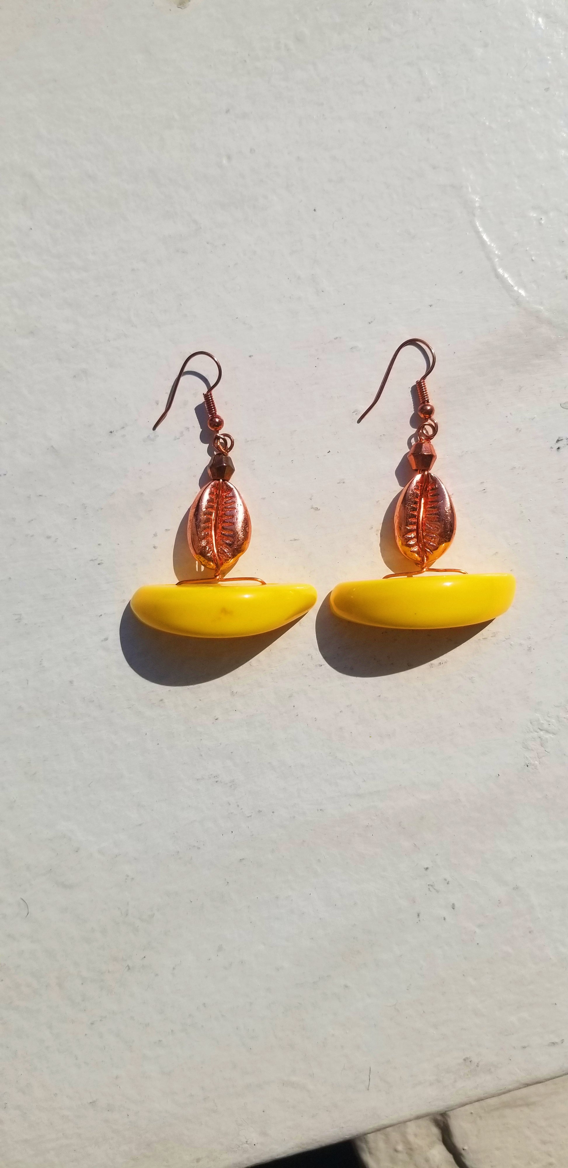 Bright canary yellow resin half-moon earrings for a bold, sunny luxury look.