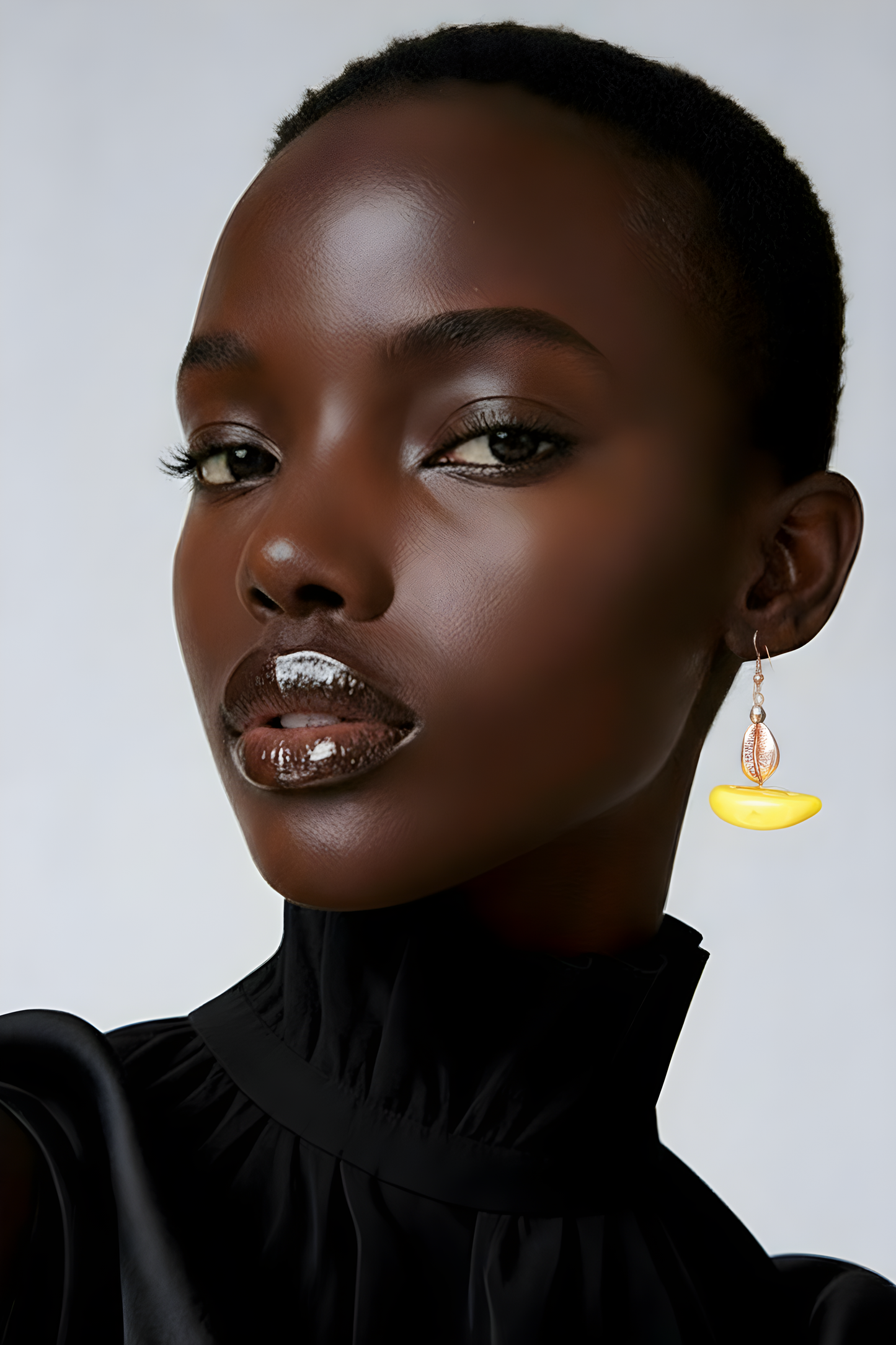 Close-up profile of a model showcasing the weightless luxury and hang of the Zora Half-Moon earrings.